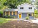 Charming two-story home with a freshly painted exterior, bright yellow door and updated shutters at 2247 Green Forrest Dr, Decatur, GA 30032