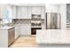 Well-lit kitchen with granite countertops, stainless steel appliances, and white cabinetry at 2247 Green Forrest Dr, Decatur, GA 30032