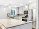 Modern kitchen with granite countertops, stainless steel appliances and decorative pendant lighting at 2247 Green Forrest Dr, Decatur, GA 30032