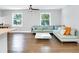 Bright living room with hardwood floors, modern ceiling fan, and a comfortable light blue sectional couch at 2247 Green Forrest Dr, Decatur, GA 30032