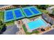 Overhead view of the tennis courts and community pool with lounge chairs at 500 Birch Forest Ln, Alpharetta, GA 30005