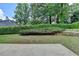 Well-maintained backyard with a stone patio and manicured greenery at 500 Birch Forest Ln, Alpharetta, GA 30005