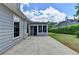Concrete patio leading to the sunroom entrance, with a well maintained yard and home exterior at 500 Birch Forest Ln, Alpharetta, GA 30005