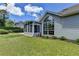 Secluded backyard featuring a sunroom, large window, and well-maintained lawn at 500 Birch Forest Ln, Alpharetta, GA 30005