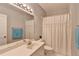 A well-lit bathroom with a vanity, mirror, and white shower curtain at 500 Birch Forest Ln, Alpharetta, GA 30005