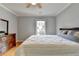 A bedroom that is well-lit and features hardwood floors and a large bed at 500 Birch Forest Ln, Alpharetta, GA 30005