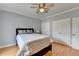 A well-lit bedroom featuring hardwood floors, ceiling fan, and double closets at 500 Birch Forest Ln, Alpharetta, GA 30005