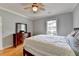Bright bedroom with natural light, ceiling fan, and a wooden dresser at 500 Birch Forest Ln, Alpharetta, GA 30005