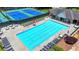 View of the community pool and surrounding lounge area with seating and tennis courts at 500 Birch Forest Ln, Alpharetta, GA 30005