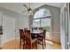 Dining room with sunlit arched window, hardwood floors, and ceiling fan at 500 Birch Forest Ln, Alpharetta, GA 30005