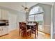 Bright dining room with large arched window and ceiling fan at 500 Birch Forest Ln, Alpharetta, GA 30005