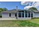 Home exterior featuring a sunroom, patio, and landscaped backyard at 500 Birch Forest Ln, Alpharetta, GA 30005