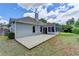 View of the home's exterior, with a concrete patio and sunroom addition visible at 500 Birch Forest Ln, Alpharetta, GA 30005