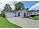 Lovely one-story home with an attached two-car garage and a large driveway at 500 Birch Forest Ln, Alpharetta, GA 30005