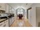 Bright kitchen with white cabinetry, granite counters, stainless appliances, and hardwood floors at 500 Birch Forest Ln, Alpharetta, GA 30005