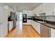 Updated kitchen featuring white cabinets and stainless steel appliances at 500 Birch Forest Ln, Alpharetta, GA 30005