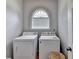 Laundry area showcasing a washer, dryer, and accent window for natural light at 500 Birch Forest Ln, Alpharetta, GA 30005