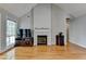 Cozy living room with fireplace, large window, and vaulted ceiling at 500 Birch Forest Ln, Alpharetta, GA 30005