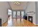 Bright living room with fireplace, hardwood floors, and large windows at 500 Birch Forest Ln, Alpharetta, GA 30005
