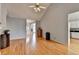 Living room featuring hardwood floors and an open layout leading to kitchen at 500 Birch Forest Ln, Alpharetta, GA 30005
