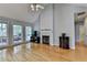 Bright living room with fireplace, hardwood floors, and large windows at 500 Birch Forest Ln, Alpharetta, GA 30005