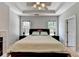 Main bedroom with hardwood floors, tray ceiling, fireplace, and sitting area at 500 Birch Forest Ln, Alpharetta, GA 30005