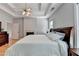 Main bedroom featuring hardwood floors, fireplace, tray ceiling, and ceiling fan at 500 Birch Forest Ln, Alpharetta, GA 30005