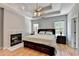 Main bedroom with hardwood floors, fireplace, tray ceiling, and ceiling fan at 500 Birch Forest Ln, Alpharetta, GA 30005