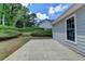 Spacious concrete patio with a view of the manicured backyard and the side of the home at 500 Birch Forest Ln, Alpharetta, GA 30005