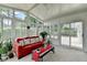 Bright sunroom with large windows, a comfortable red couch, and sliding doors to the patio at 500 Birch Forest Ln, Alpharetta, GA 30005