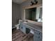 Bathroom featuring gray vanity with a gray countertop and decorative mirror at 563 Fieldgreen Dr, Jonesboro, GA 30238
