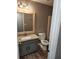 Modern bathroom with gray walls, neutral vanity with granite counters, and tub/shower combo at 563 Fieldgreen Dr, Jonesboro, GA 30238