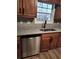 Stainless steel dishwasher, sink, granite counters, and cherry cabinets at 563 Fieldgreen Dr, Jonesboro, GA 30238