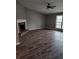 Living room with tall vaulted ceiling, modern fan, and brick fireplace at 563 Fieldgreen Dr, Jonesboro, GA 30238