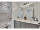 Beautiful bathroom featuring a double vanity, tub/shower, and modern fixtures at 7014 E Hills Way, Woodstock, GA 30189