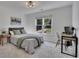 Bedroom with carpet, two windows for natural light and a dark wood bed frame at 7014 E Hills Way, Woodstock, GA 30189