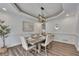 Bright dining room with a modern light fixture and comfortable seating arrangement at 7014 E Hills Way, Woodstock, GA 30189