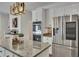 Bright kitchen with granite countertops, stainless steel appliances, and custom cabinets at 7014 E Hills Way, Woodstock, GA 30189