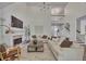 Spacious living room with fireplace, hardwood floors, and abundant natural light at 7014 E Hills Way, Woodstock, GA 30189