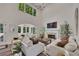 Bright, airy living room featuring high ceilings, fireplace, and modern furnishings at 7014 E Hills Way, Woodstock, GA 30189