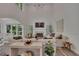 Bright living room features a fireplace, high ceilings, and large windows for natural light at 7014 E Hills Way, Woodstock, GA 30189
