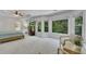 Spacious primary bedroom with sitting area, tray ceilings, and large windows at 7014 E Hills Way, Woodstock, GA 30189