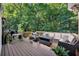 Inviting outdoor deck with comfortable seating and lush greenery at 7014 E Hills Way, Woodstock, GA 30189