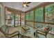Relaxing screened porch with comfortable seating and a view of the lush trees at 7014 E Hills Way, Woodstock, GA 30189