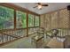 Cozy screened porch with comfortable seating, perfect for enjoying the outdoors at 7014 E Hills Way, Woodstock, GA 30189