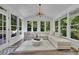 Light-filled sunroom with floor-to-ceiling windows and comfortable seating area at 7014 E Hills Way, Woodstock, GA 30189