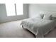Neutral bedroom with white headboard, carpet, and large windows providing ample natural light at 20 Geranium Ln, Covington, GA 30016