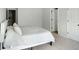 Bedroom with white walls and carpet, a bed with white linens, and doorways to other rooms at 20 Geranium Ln, Covington, GA 30016