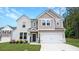 Beautiful two-story home with a manicured lawn, attached two car garage, and appealing neutral color palette at 20 Geranium Ln, Covington, GA 30016