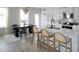 Bright kitchen with white cabinets, a center island with seating, stainless steel appliances, and a dining area at 20 Geranium Ln, Covington, GA 30016